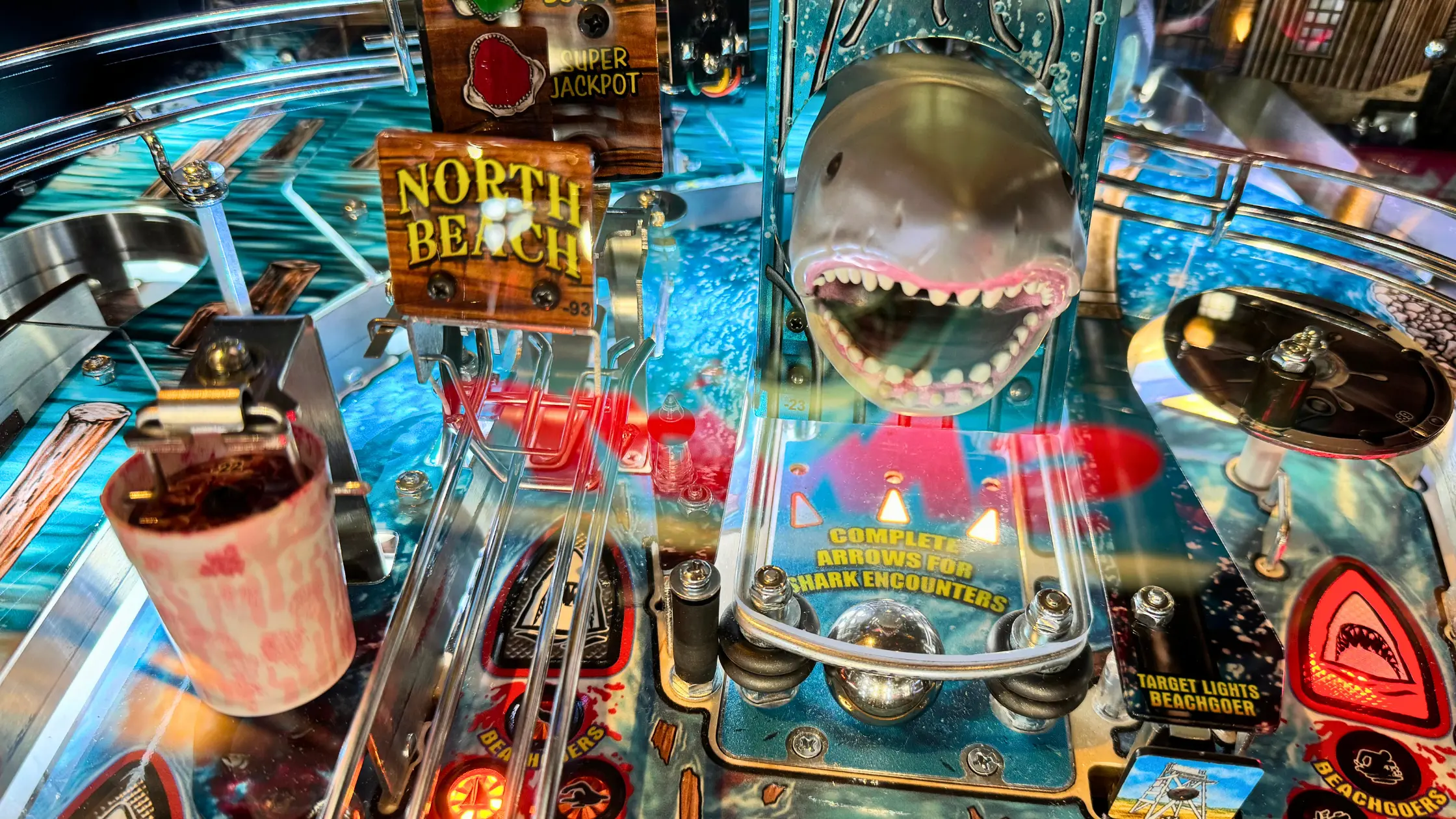 Jaws-themed pinball machine with shark mouth and North Beach sign